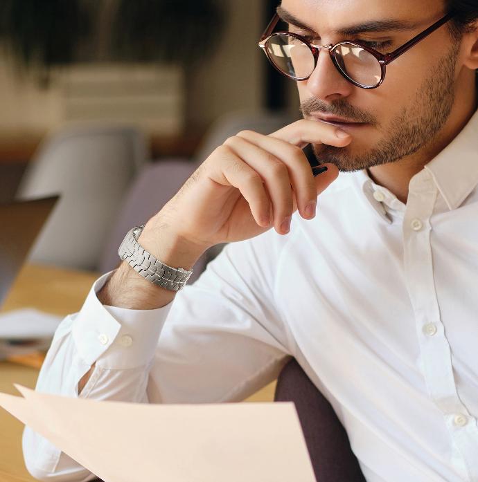 Stainless Steel Apple Watch Strap alt="man reading a paper while wearing his stainless steel watch"